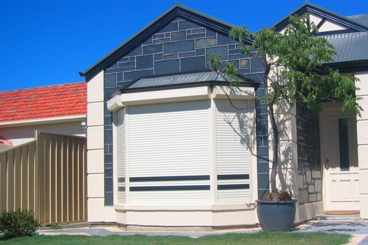 Roller shutters on bay window