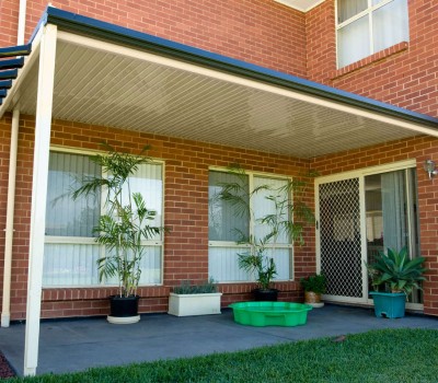 Flat verandah off two storey wall